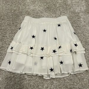 Storia size S star skirt in white. Perfect condition. Never been worn.Has liner